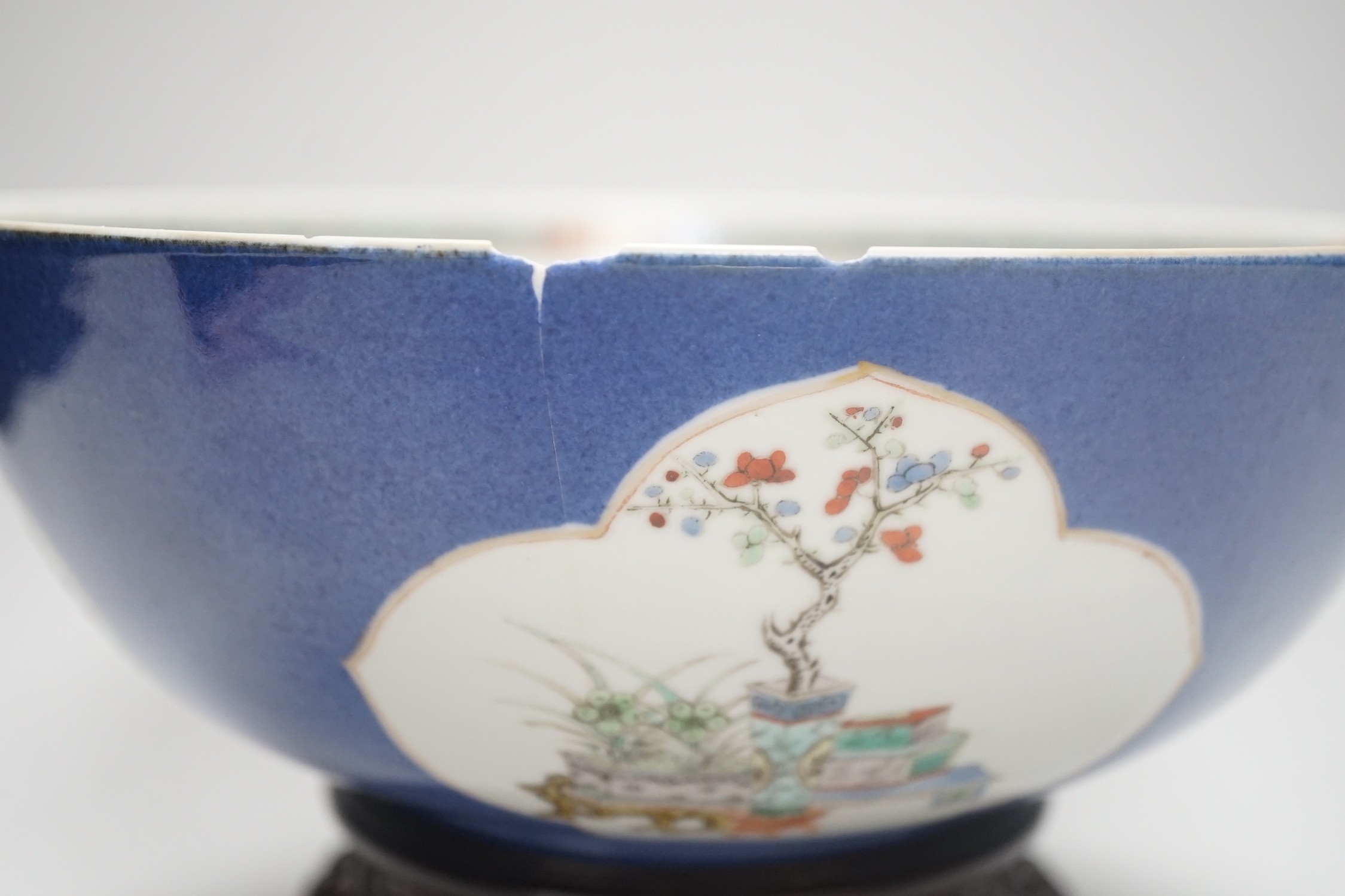 A 19th century Chinese famille verte powder blue bowl, 26cm diameter, wood stand